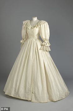 an antique wedding dress is displayed on a mannequin's headdress