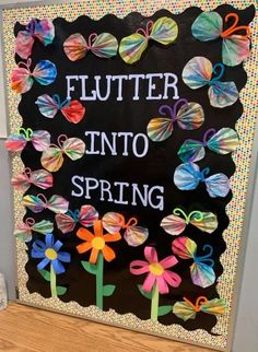 a bulletin board with flowers and butterflies on it that says, flutter into spring written in white letters