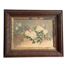 a painting with white flowers in a wooden frame