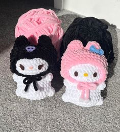 two crocheted hello kitty slippers sitting next to each other on the floor