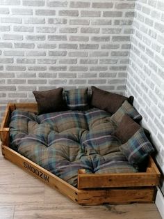 a dog bed made out of wooden pallets