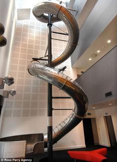 a large metal slide in the middle of a room