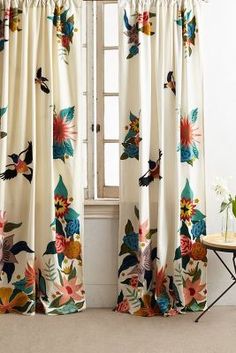 the curtains are decorated with flowers and birds