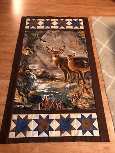 two deer standing next to each other on top of a wooden floor in front of a rug