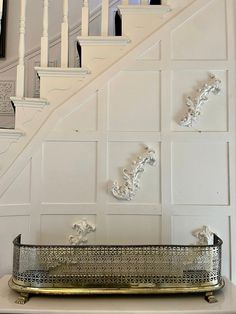 a metal tray sitting on top of a white table next to a bannister