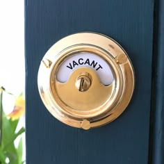 a door handle with the word vacant on it and flowers in the background