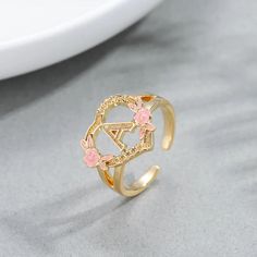 Material: Copper. Color: Gold, White Gold. Size: 5.0, 5.5, 6.0, 6.5, 7.0, 7.5, 8.0, 8.5, 9.0, 9.5, 10. Process: Gold plated. Recipient: Women, Mom, Wife, Girl Friend, Children, Family. Product Type: Personalized Jewelry. Gift Type: Ring. Occasions: Valentine's Day, Mother's Day, Christmas, Birthday, etc. Ring Type: Name Ring. Brand: Silviax Jewelry. Spring Rose Gold Flower Ring, Gold Flower Rings For Spring, Gold Floral Rings For Spring, Spring Flower-shaped Gold Rings, Spring Gold Jewelry, Letter Ring, Name Rings, Girl Friend, Pink Enamel