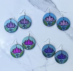 These lightweight wood earrings showcase a sweet little sketch of a lotus flower. They're hand painted with color shifting and holographic watercolor. Earrings are varnished so there's no paint transfer, but they're not waterproof.  Earring hooks are 925 sterling silver plated with silicone backs included.  Four pairs available:  Purple Lotus w/blue green hoLo background  Pink HoLo Lotus w/blue hoLo background  Fuchsia Color Shift Lotus with green hoLo background  Purple HoLo Lotus with blue hoL Holo Background, Lotus Sketch, Fire And Ice Roses, Watercolor Earrings, Purple Lotus, Background Purple, Background Pink, Personalized Artwork, Sunset Colors