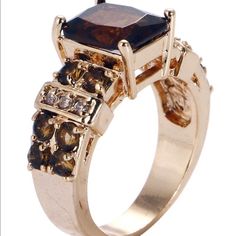 a gold ring with brown and white stones