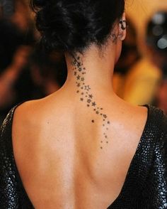 the back of a woman's neck with stars on it