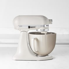 a white mixer sitting on top of a counter