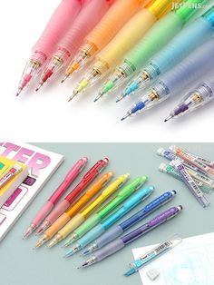 several different colored pens sitting next to each other