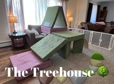 the treehouse is made out of several pieces of cardboard and sits in front of a living room