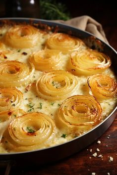 a casserole dish with onions and cheese