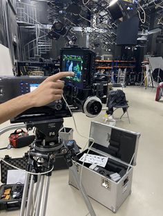 a camera set up in a large room with lots of equipment on the floor and around it