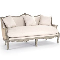 a white couch with some pillows on it