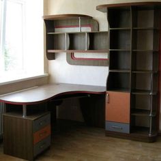 a corner desk and bookcase in an empty room