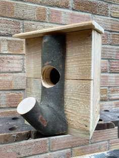 a bird house built into the side of a brick wall