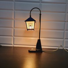 a lamp that is sitting on top of a wooden table next to a garage door