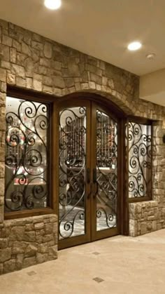 an advertisement for a wine cellar with glass doors and wrought ironwork on the front