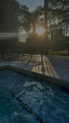 the sun shines brightly on an empty swimming pool