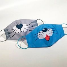 two children's face masks, one with a cat and the other with a mouse