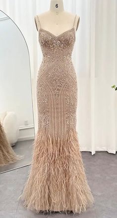 The champagne gown showcases a V-neckline and is adorned with bead and embellishments, adding a touch of shimmer. The ostrich feathers enhance its elegance, creating a graceful and ethereal silhouette. Production time is between approx 6-8 weeks. * Sizing - All items are made according to measurement ranges, they are NOT typical letter or numeric sizing. It is imperative to compare your exact measurements with the size chart provided either in the listing photos or item descriptions and to also add your measurements under Personalization. If you have any questions on sizing, please feel free to message me. Do not order your normal size without taking and comparing measurements. * EXCHANGES ONLY. Returns will not be accepted. I have explained the importance of adding your exact measurements Pearl Fringe Dress, Beaded Wedding Dress Crystal, Great Gatsby Gown, Gatsby Gown, Wedding Dress With Feathers, Champagne Gown, Crystal Wedding Dresses, Feather Gown, Dresses Fancy