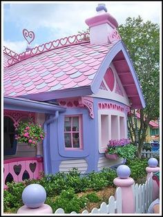 a pink and blue house with hearts on the roof