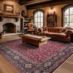 a living room with couches, chairs and a rug in front of a fireplace