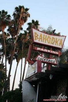 the sign for bahoka's bar and grill in front of palm trees