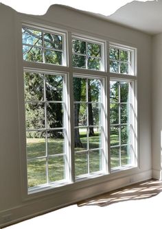 an empty room with three large windows in it