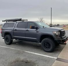 a gray truck parked in a parking lot