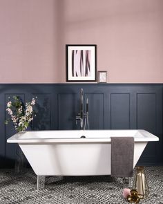 a bathtub in a bathroom with pink walls