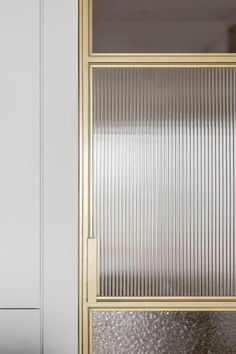 an image of a door with glass on the front and side panels that are gold