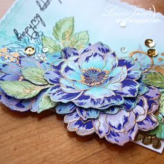 a close up of a blue flower on a wooden table with words written on it