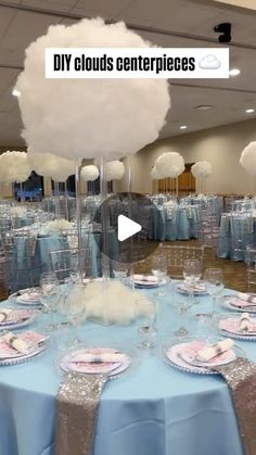 a room filled with tables covered in blue cloths and white fluffy clouds on top of them