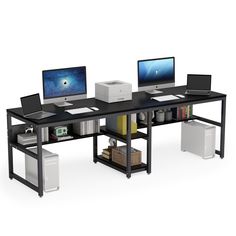 a computer desk with two computers on it and a printer in front of the monitor