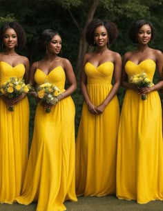 four beautiful women in yellow dresses standing together