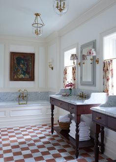 a bathroom with checkered flooring and two sinks in front of a tub, chandelier