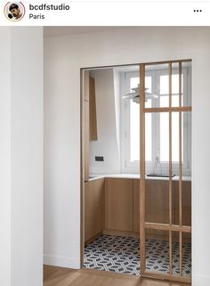 an empty kitchen with wooden cabinets and white walls