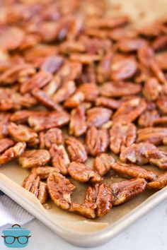 a tray filled with pecans sitting on top of a table