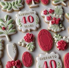 decorated cookies are displayed on a table for celebrating 40 years in the form of flowers