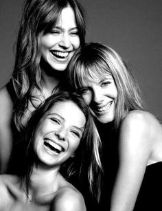 three women are smiling and posing for the camera