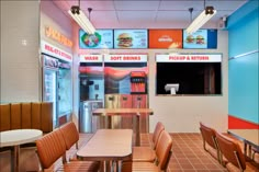 the inside of a fast food restaurant with tables and chairs