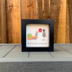 a black frame with a picture of two birds on it