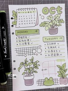 an open planner with plants on it next to a pen