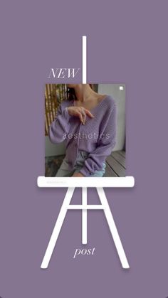 a woman in purple sweater sitting on top of a white easel with the words new post