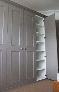 an empty closet with several doors and shelves