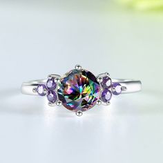 A ring as unique as you are! This sterling silver ring is set with a rainbow topaz and an amethyst, both of which have been faceted to catch the light. The result is a ring that's dazzling and eye-catching, perfect for any special occasion. Throughout history, mystic topaz has been associated with healing and good luck. As well as bringing good fortune, the stone is believed to have the power to ward off evil (or negative energy) while boosting your energy and positive feelings. Metals Type: 925