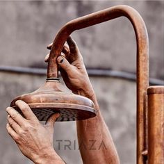 an old man is washing his hands on the faucet